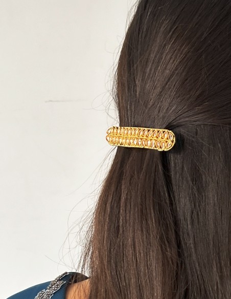 Golden barrette with pink crystals in the shape of leaves