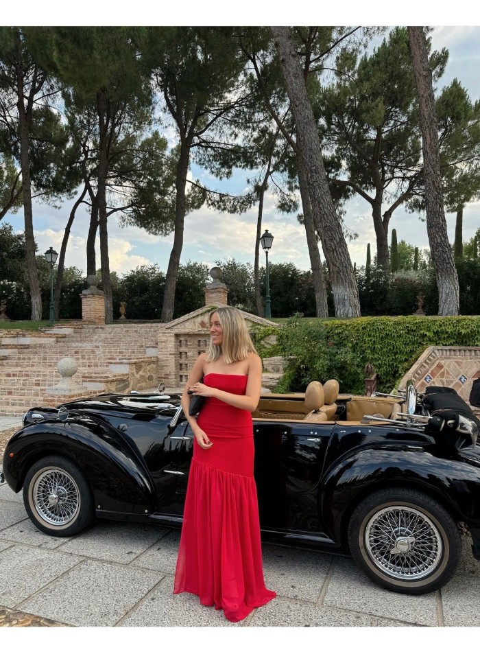 Long red strapless dress with maxi ruffle skirt