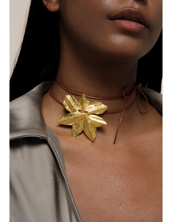 Golden necklace in the shape of lotus flower