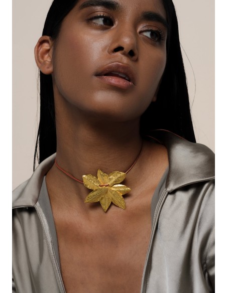 Golden necklace in the shape of lotus flower