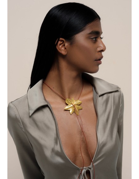 Golden necklace in the shape of lotus flower