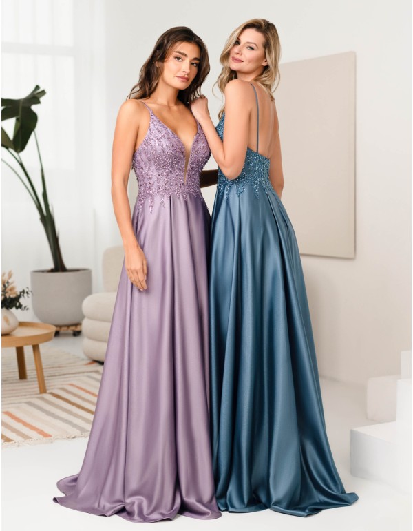 vestidos de invitada en color azul y lila con cuerpo de pedrería y falda de satén.