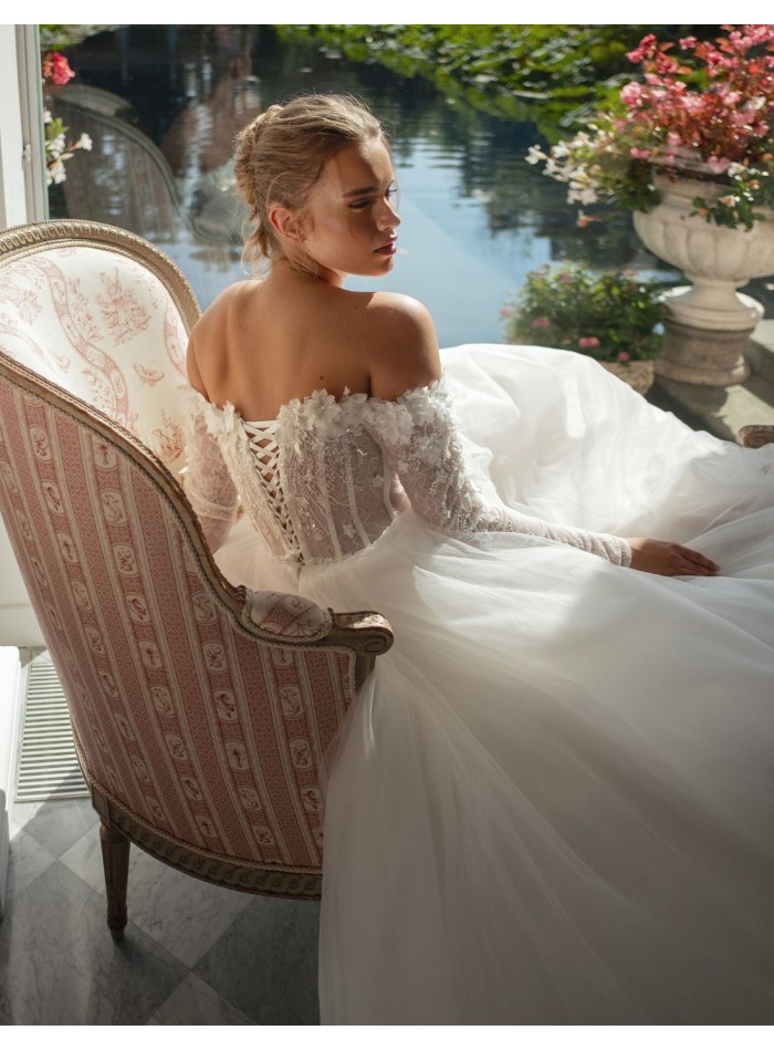 Long ivory wedding dress with lace neckline and...