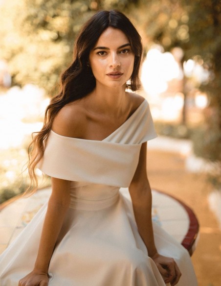 Wedding dress with crossover bateau neckline and flared skirt