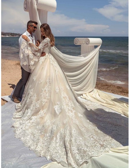 Princess wedding dress with long sleeves in tulle and guipure semi-transparent effect at INVITADISIMA