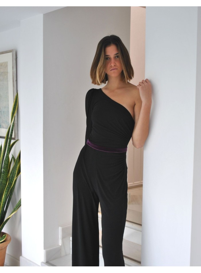 Black jumpsuit with purple waistband and asymmetrical neckline