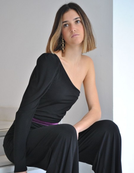 Black jumpsuit with purple waistband and asymmetrical neckline