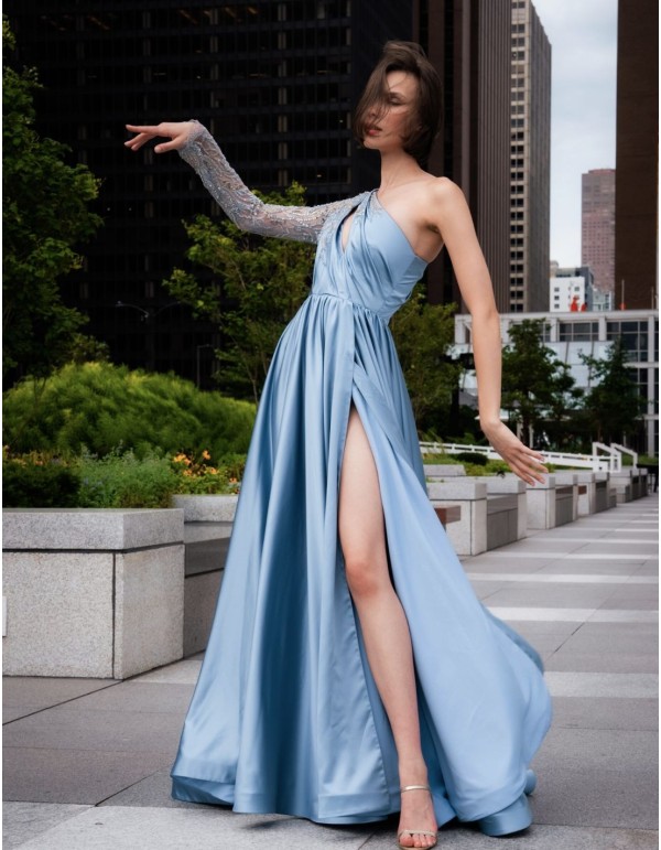 Long party dress with asymmetrical neckline and sleeves with rhinestones and transparencies.