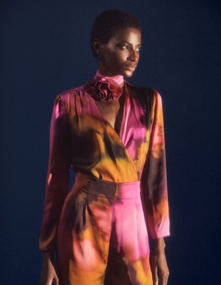 Satin party blouse with crossover neckline and floral embellishment