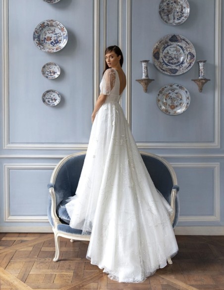 Wedding dress with sheer short sleeves and flowing skirt