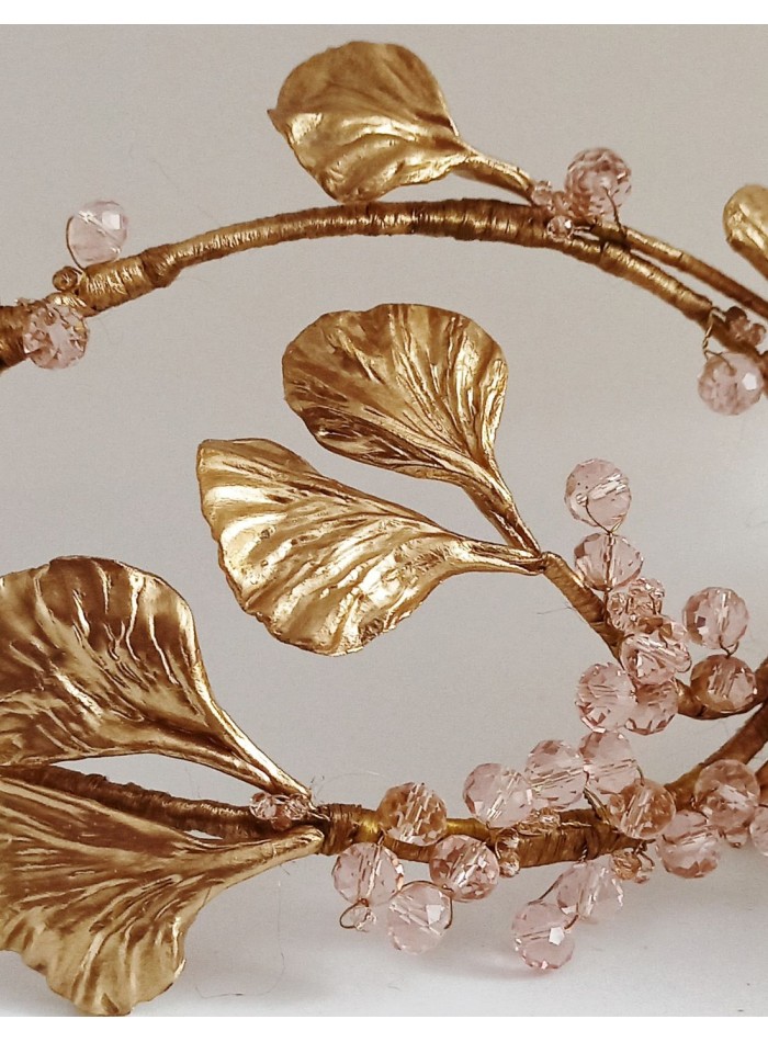 Golden bridal headdress with leaves and crystals.