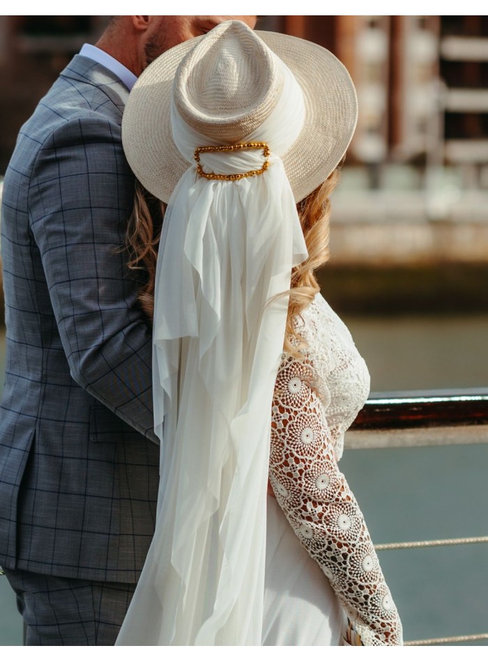 White buntal hat with golden metallic buckle.