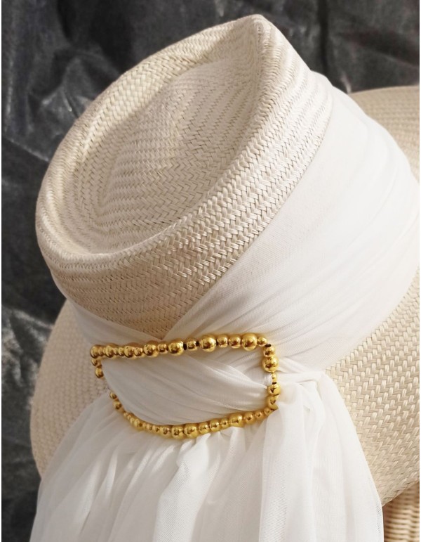 Bridal or guest hat with veil and ball buckle.
