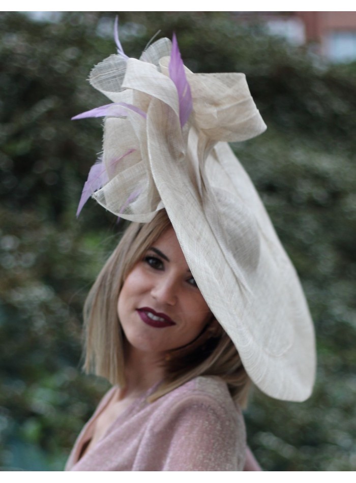 Raffia pamela with purple feathers.