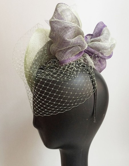 Veiled guest headpiece with raffia details.