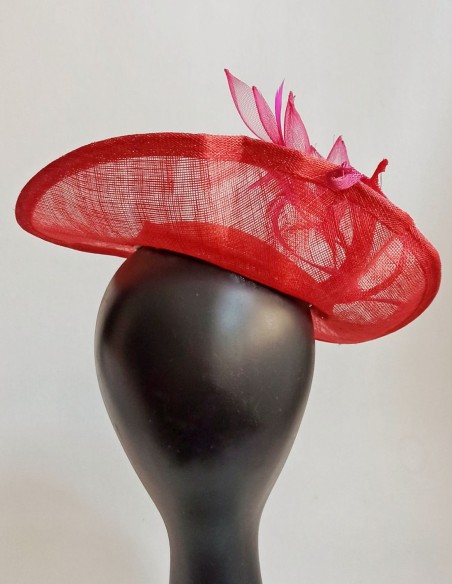 Dish style headpiece with feathers and flowers for guests.