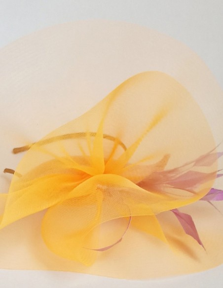 Tocado naranja con plumas para invitadas.