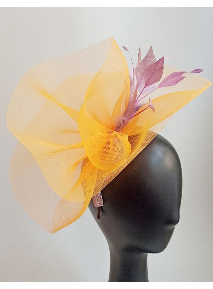 Yellow raffia headdress with mauve feathers.