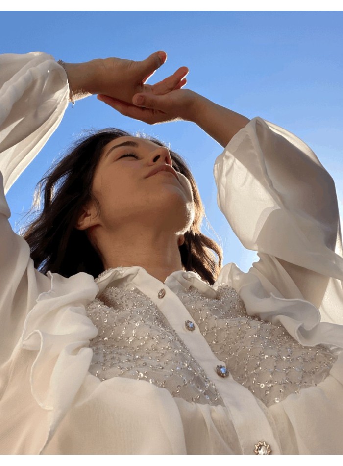 White party blouse with ruffles and crystals