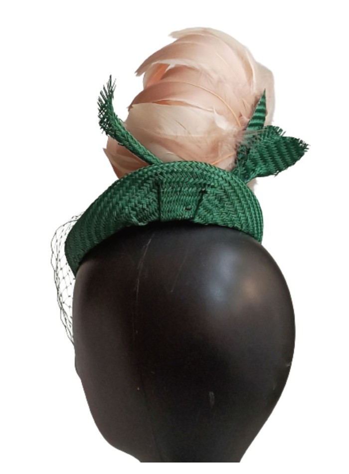 Green headpiece with veil over the face.