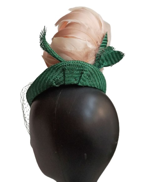 Green headpiece with veil over the face.