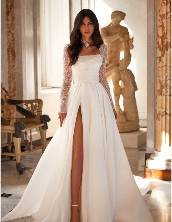 Long wedding dress with straight neckline and embroidered sleeves with rhinestones