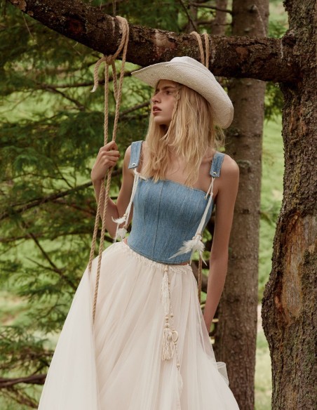 Blue denim corset with decorative feathers