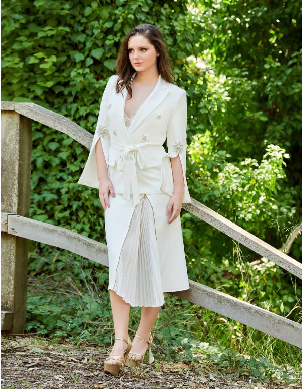 White jacket and pleated skirt set.