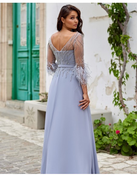 Long party dress with feather appliqués and rhinestones