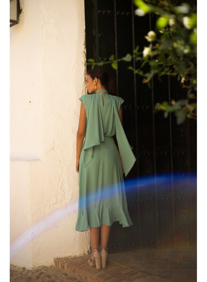 Top and skirt set with aqua green flouncy cross...