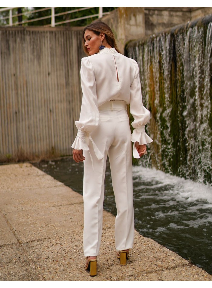 White blouse with long sleeves and ruffled details