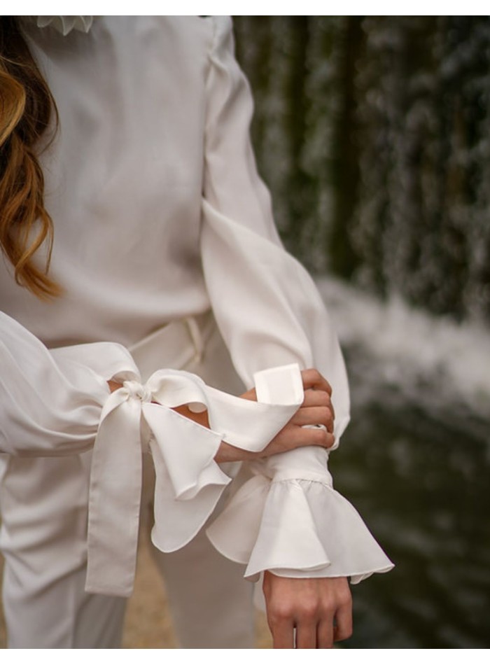 White blouse with long sleeves and ruffled details