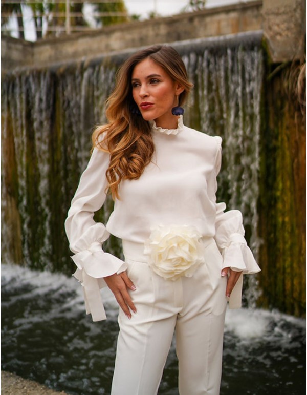 White blouse with long sleeves and ruffled details
