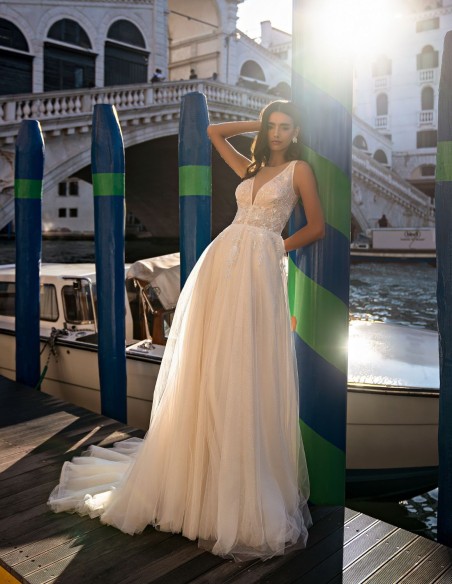 Ivory long wedding dress with V-neckline and beaded bodice