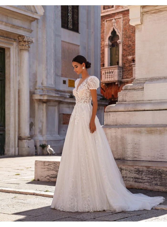 Long wedding dress in floral embroidered tulle...