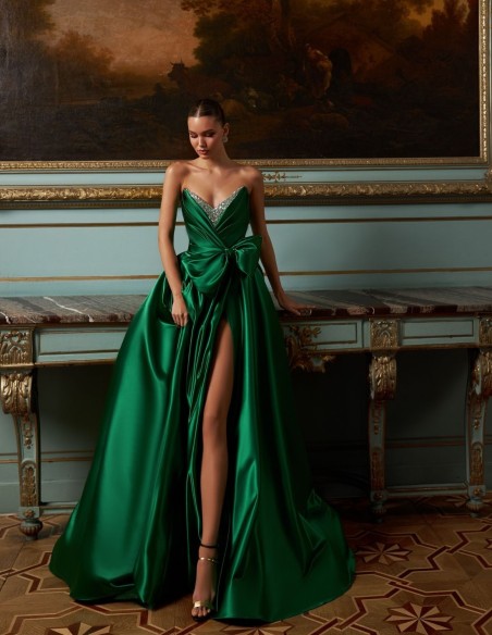 Long evening gown in emerald green satin with embellished neckline and maxi bow skirt