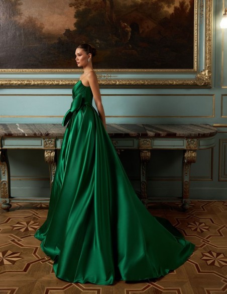 Long evening gown in emerald green satin with embellished neckline and maxi bow skirt