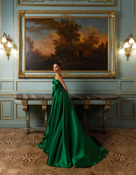 Long evening gown in emerald green satin with embellished neckline and maxi bow skirt