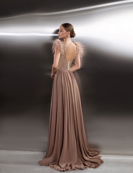 Long party dress with shimmering bodice and feathered shoulders